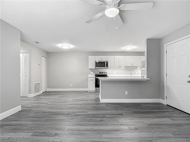 Kitchen featuring white cabinets, dark wood-style