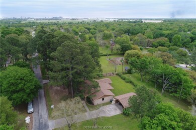 Aerial view showing huge trees, house, carport bac