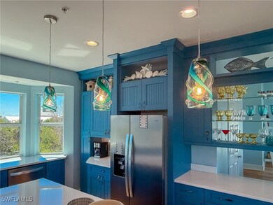 Kitchen with light countertops, blue cabinetry, ap