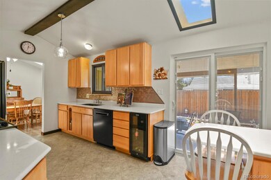 Kitchen with wood beam, skylight and vaulted ceili