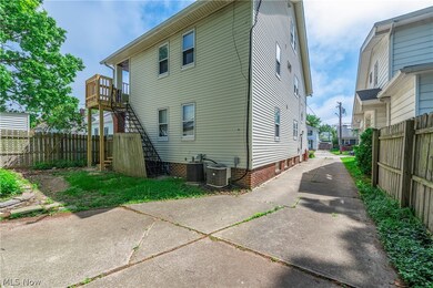 Rear view of property with central AC