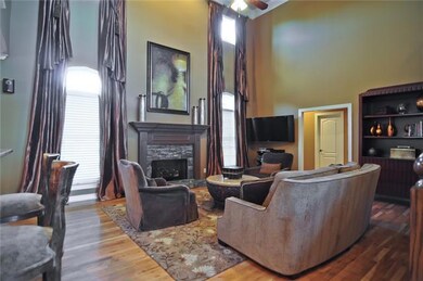 Two -Story Family Room with fire place and large windows.