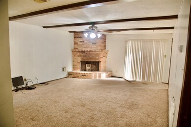 Living room with fireplace and beautiful wood beam