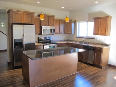 Kitchen - laminate floor, refrig stays