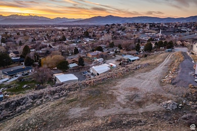 Aerial overview of property's location featuring a mountain backdrop and nearby suburban area