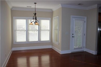 Like New Hardwood Floors, Deep Moldings, Neutral Paint and Natural Light Brighten the Dining Room! 