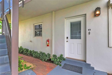 Entrance to property with stucco siding