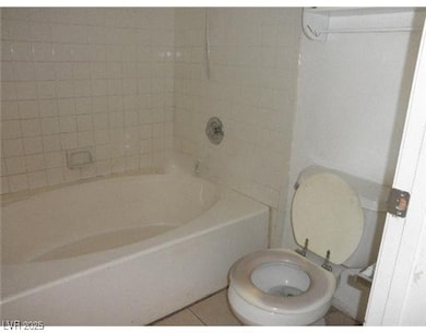 Bathroom with tile patterned flooring and tub / shower combination