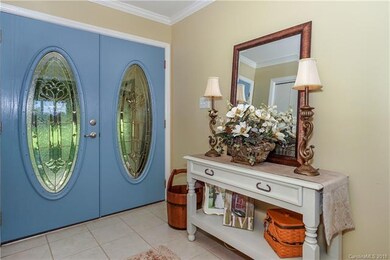 Light-filled foyer - crown molding & neutral paint