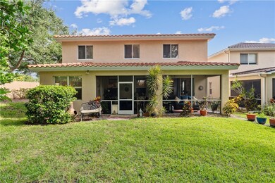 Rear view of property with a sunroom and a yard