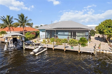 Dock area featuring a water view, boat lift, and a sunroom