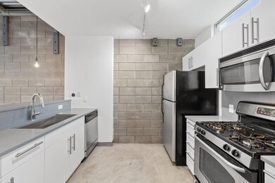 Kitchen featuring light countertops, concrete flo
