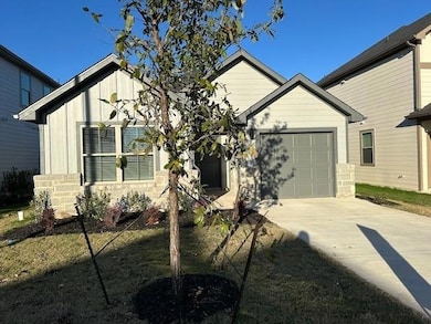 View of front of property with driveway and an at