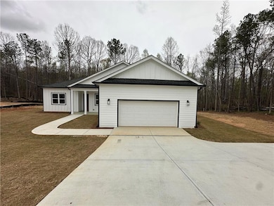 View of front of property featuring driveway, an a
