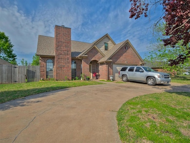 View of front facade featuring roof with shingles, brick siding, concrete driveway, a chimney, and an attached garage