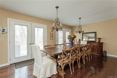 Two sets of new double French doors lead to the ba