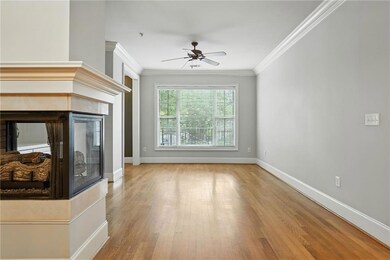Unfurnished living room with light wood-type flooring, ornamental molding, a multi sided fireplace, and a ceiling fan