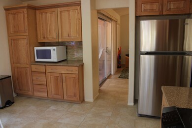 Kitchen view, refrigerator and pantry