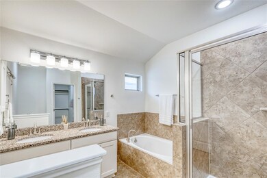 Bathroom with a shower stall, a garden tub, doubl