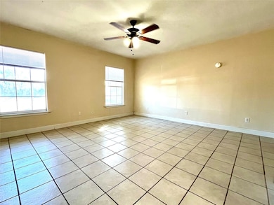 Spare room featuring light tile patterned floorin