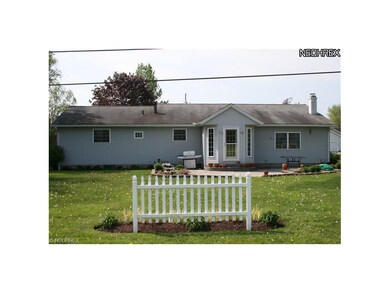 Back of home with paver patio and nice yard.