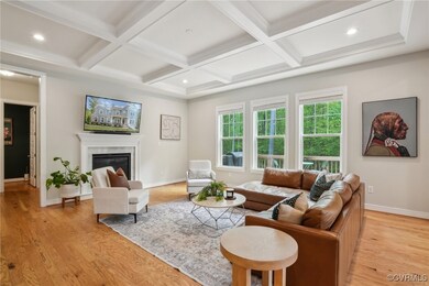 Living room featuring beamed ceiling, light wood-s