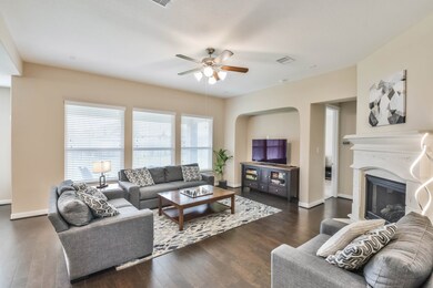 Living room with fireplace open to breakfast nook and kitchen