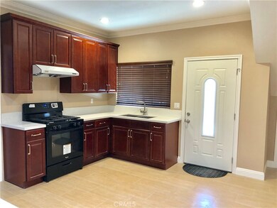 Open kitchen with recessed lighting, quartz countertops, & cherry wood cabinets