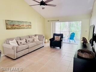 Living room with ceiling fan, tile patterned floor