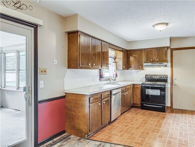 Kitchen and sunroom entrance and garage man door.