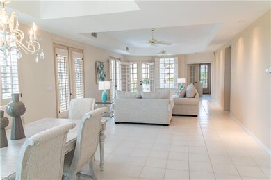 Living room featuring ceiling fan with notable cha