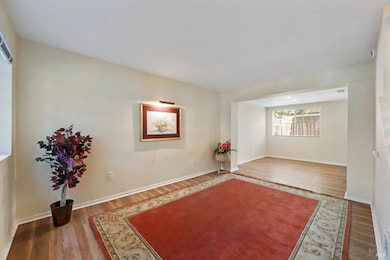 Living room with office or formal dining room in back.