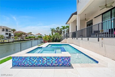 View of swimming pool with a ceiling fan, a water