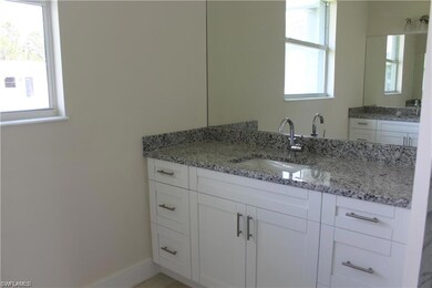 Bathroom featuring vanity and baseboards