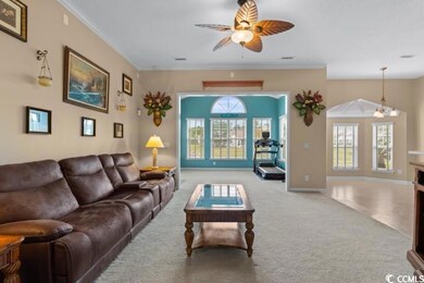 Living room featuring ceiling fan with notable cha