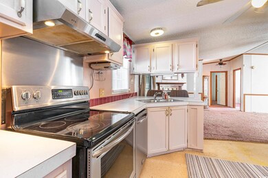 Kitchen featuring ceiling fan, stainless steel app