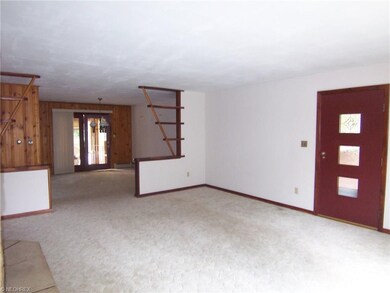 Living room with front door entrance and view to d