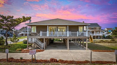 View of front of home featuring stairs, roof with 