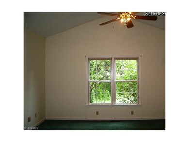Vaulted Master BR looks out to rear yard and trees