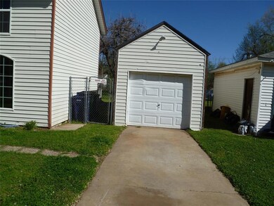 Garage featuring a lawn