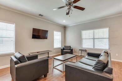 Living room with ornamental molding, ceiling fan, light wood finished floors, healthy amount of natural light, and recessed lighting