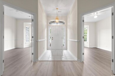 Entryway featuring ornamental molding, ceiling fan