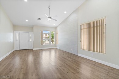 Unfurnished living room featuring ceiling fan, bas