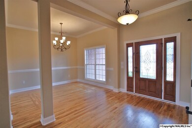 Gorgeous hardwoods, elaborate front door, and crown molding.