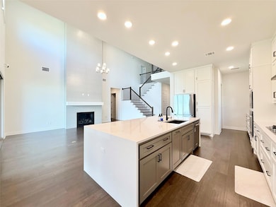 Kitchen featuring dark wood-type flooring, applia
