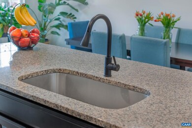 Kitchen features granite counters, gas cooking, an