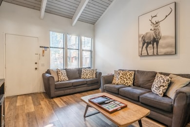 Living area with wood finished floors and wooden ceiling