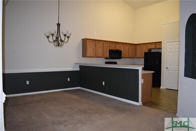 Formal dining room with chandelier looking into th