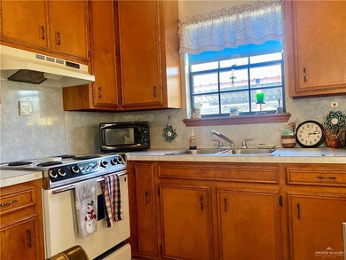 Kitchen with sink, tasteful backsplash, and range with gas stovetop