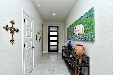 Entrance foyer with a textured wall and light tile patterned flooring